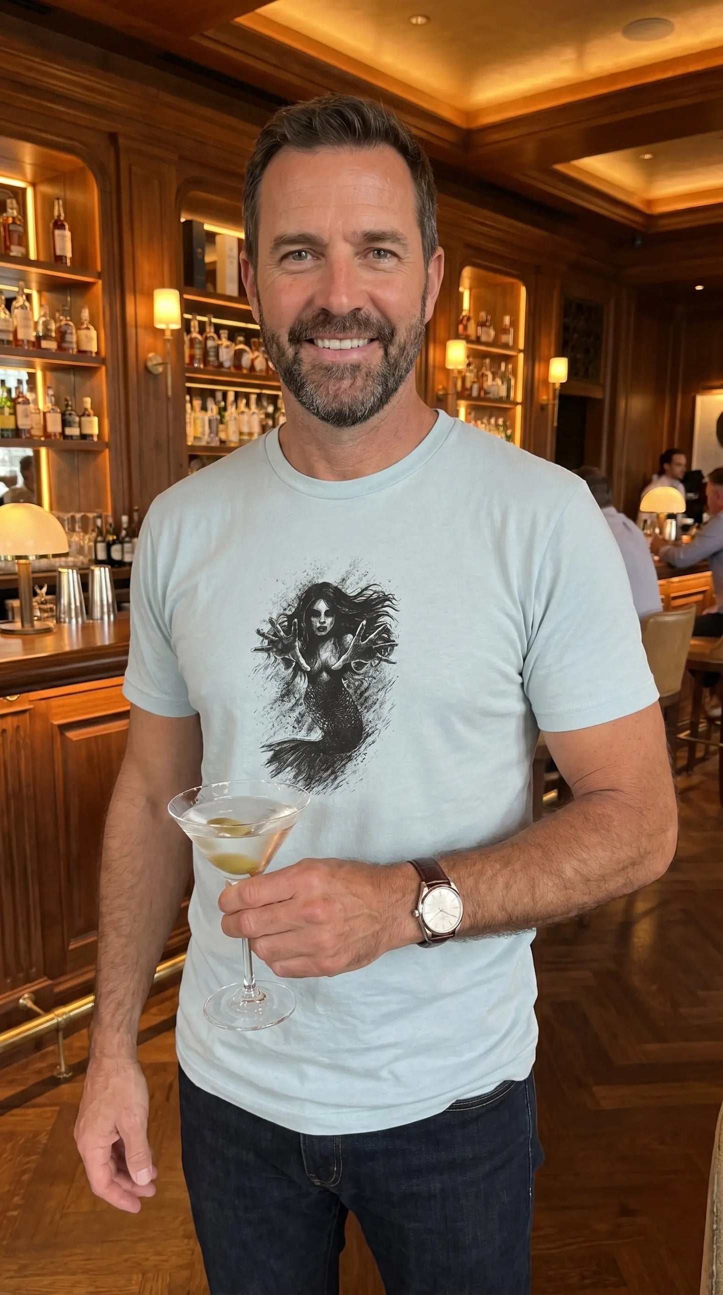 Man holding a cocktail in a bar setting
