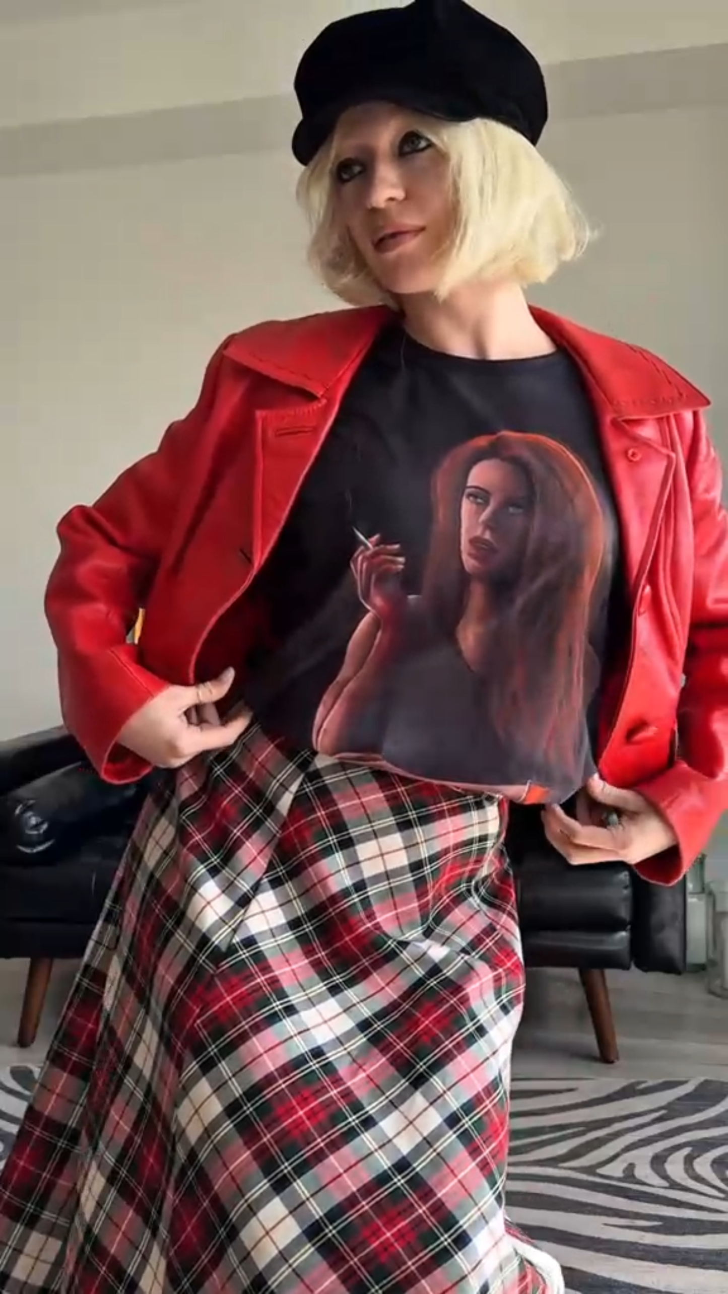 Person wearing Storyteller's Closet Grace t-shirt red jacket and plaid skirt.