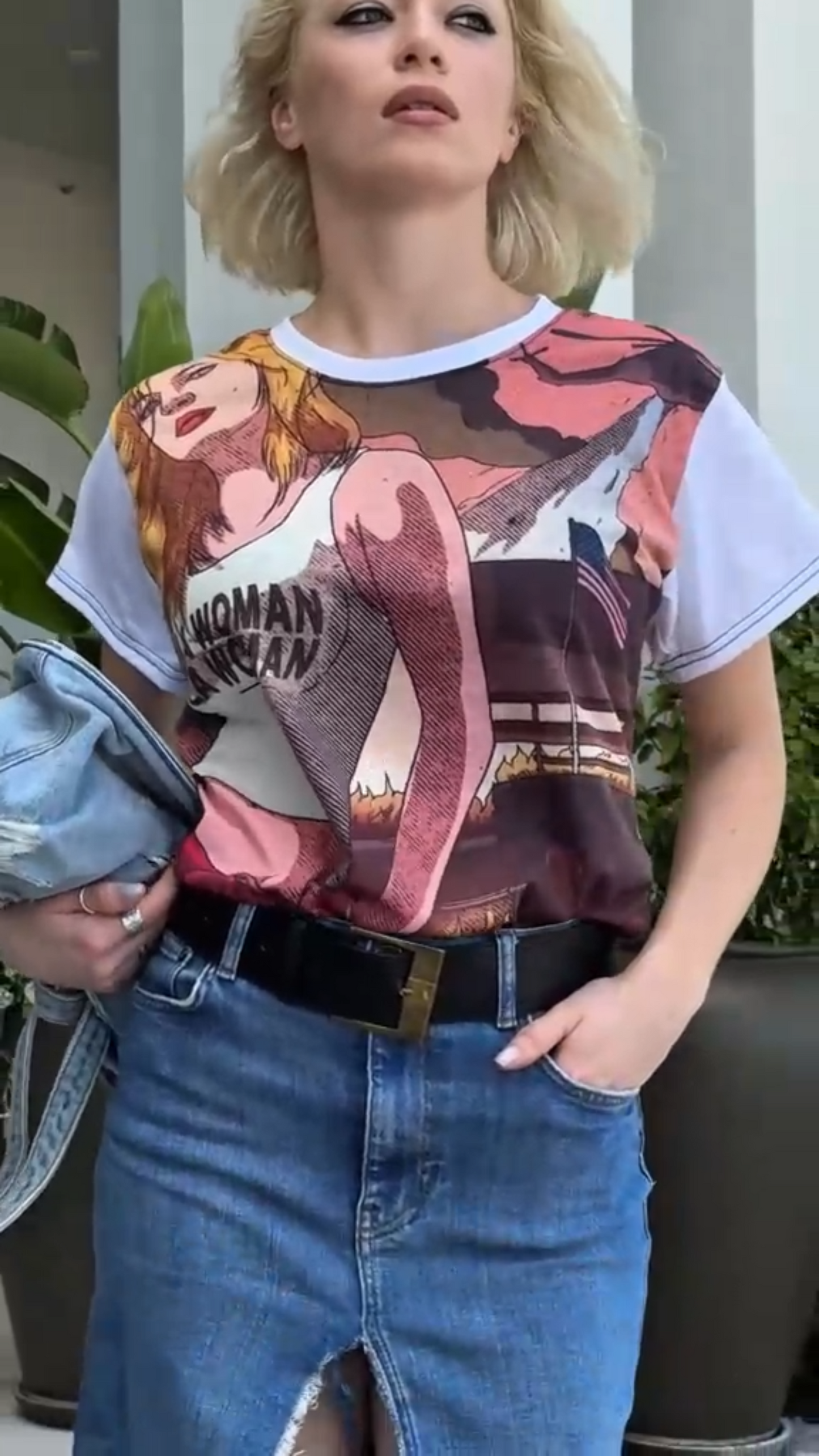 Person wearing a graphic t-shirt with a prominent design.